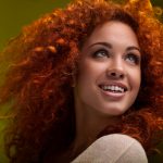 Red Hair. Beautiful Woman with Curly Long Hair. High quality ima